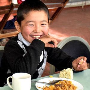 Boy smiling at lunch