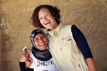 Su’ad jarbawi smiling with arm around a program participant