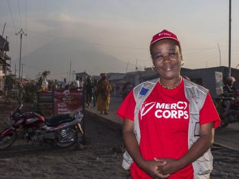 The drc director of communications odette poses for a picture in front of mount nyiragongo volcano.