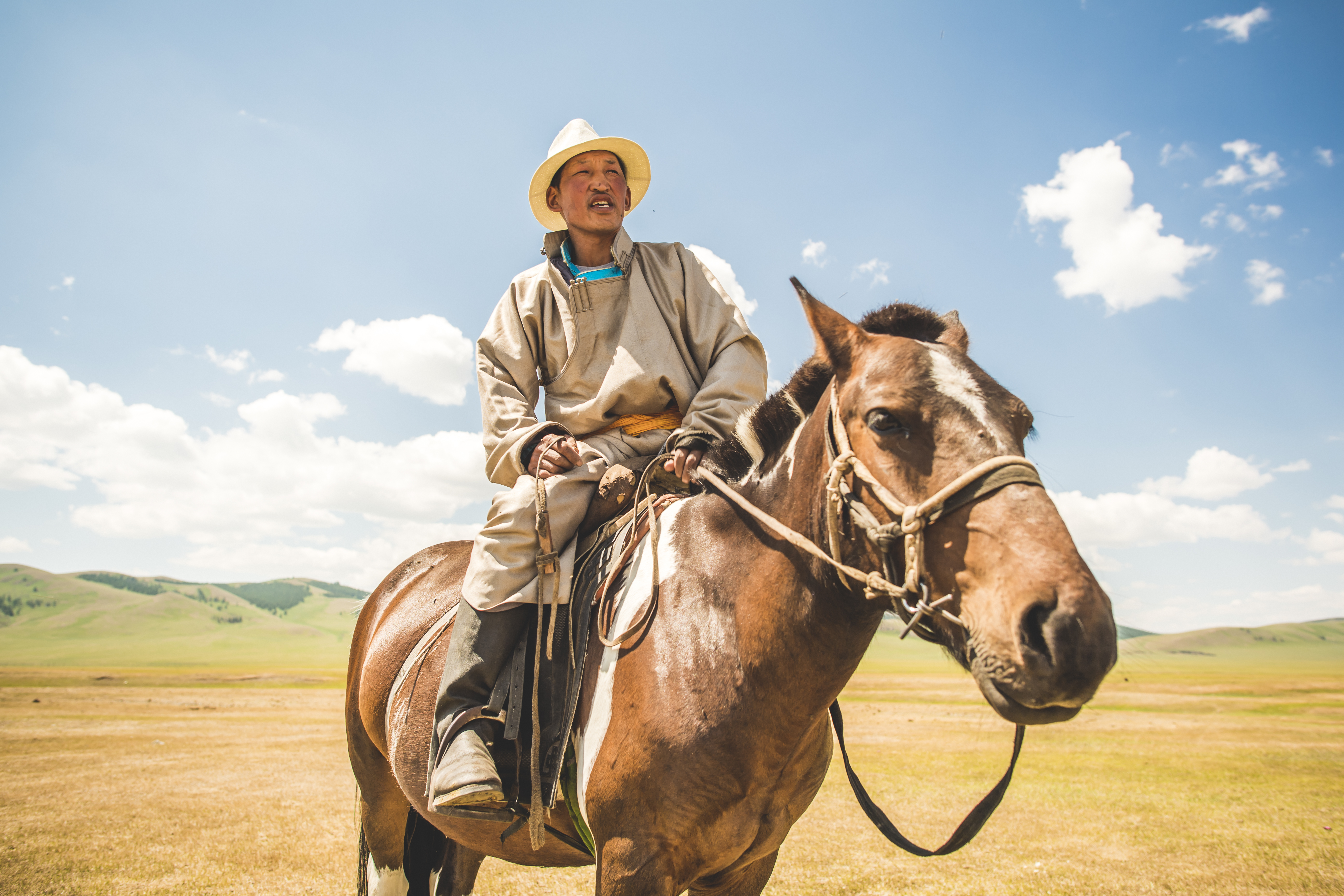 Batsaikhan, 40, is a nomadic herder in central mongolia, where life depends on the dramatic turns of the weather. mercy corps is helping herders like him strengthen their animals so they can earn steady incomes and feed their families through the brutal winter. here, batsaikhan is pictured on horseback.