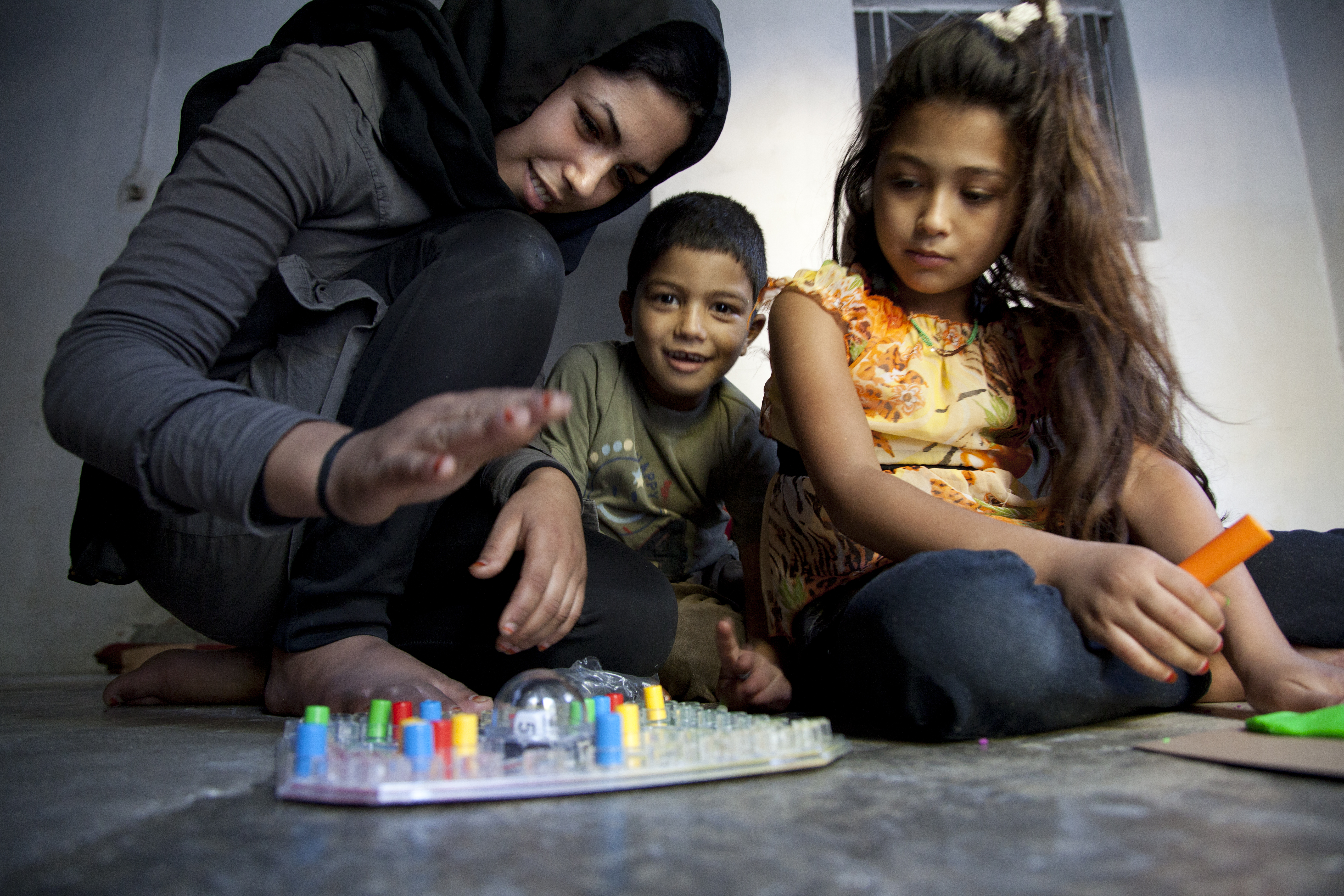A young boy and girl playing a board game