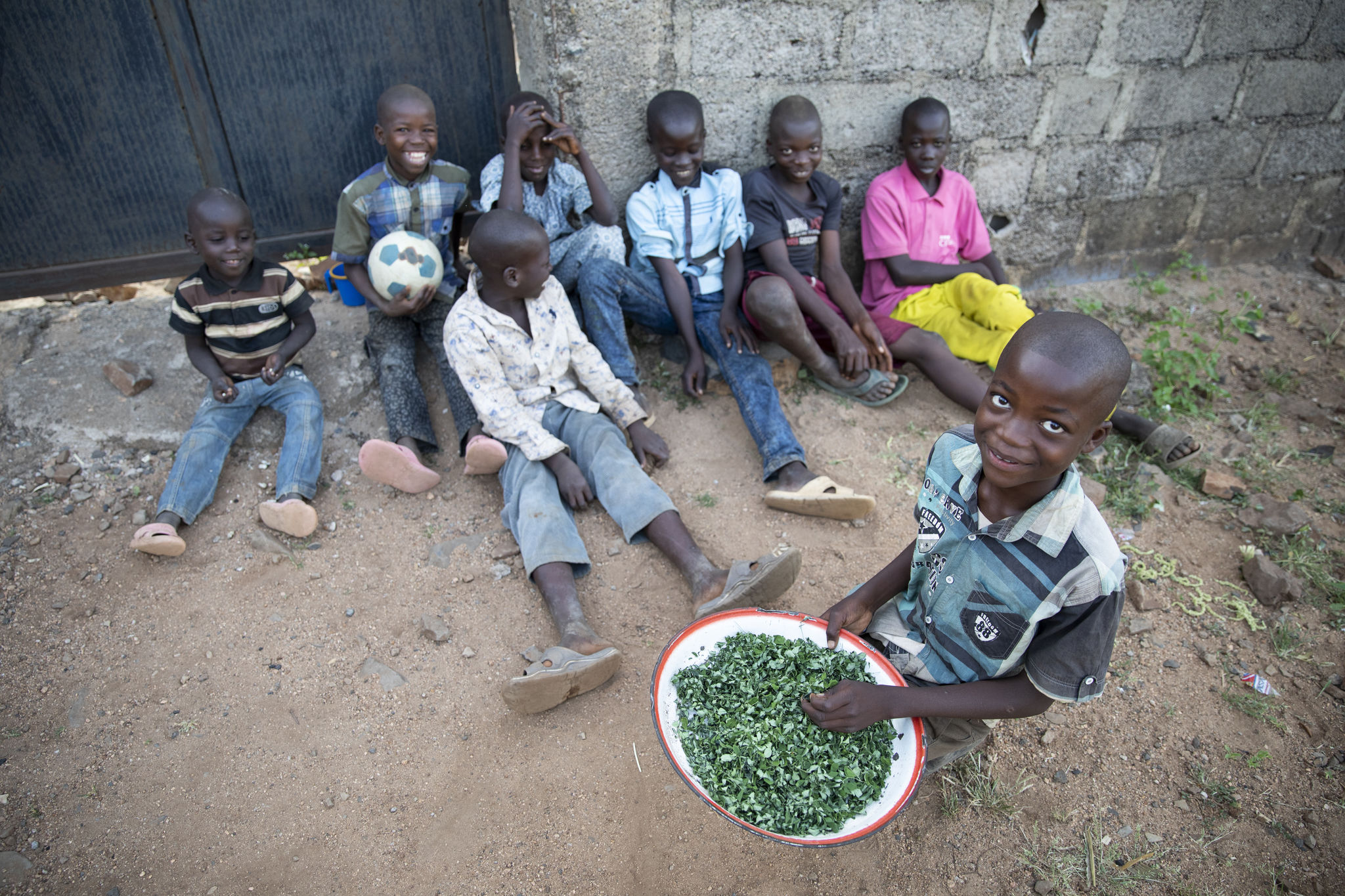 Eight children pictured in Nigeria. Their caretaker has struggled immensely to feed them with what she can grow and cultivate herself on land she pays to rent. Photo: Ezra Millstein/Mercy Corps