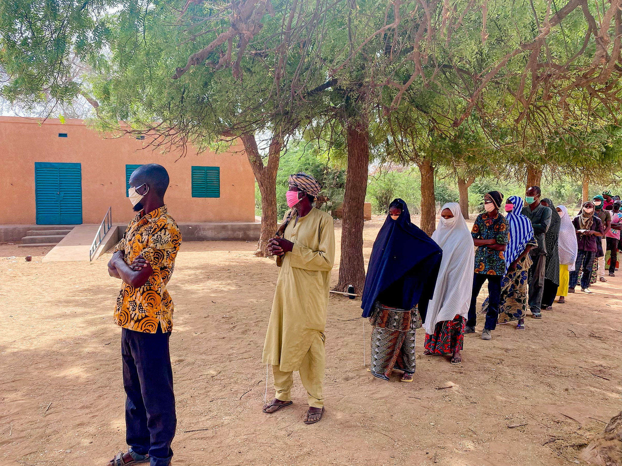 People line up six feet apart to keep from spreading COVID-19. 