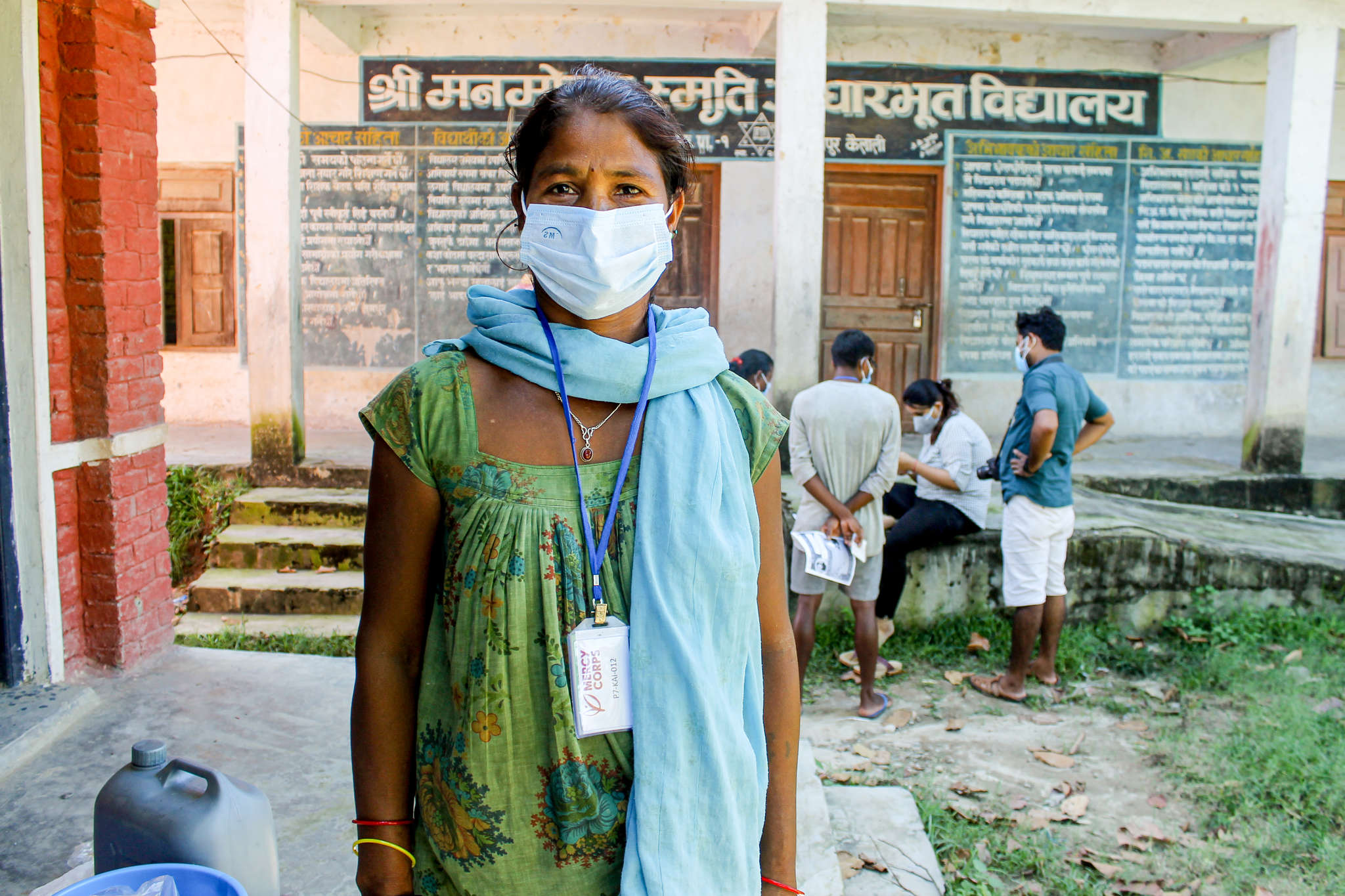 A person faces the camera while wearing a face mask. 