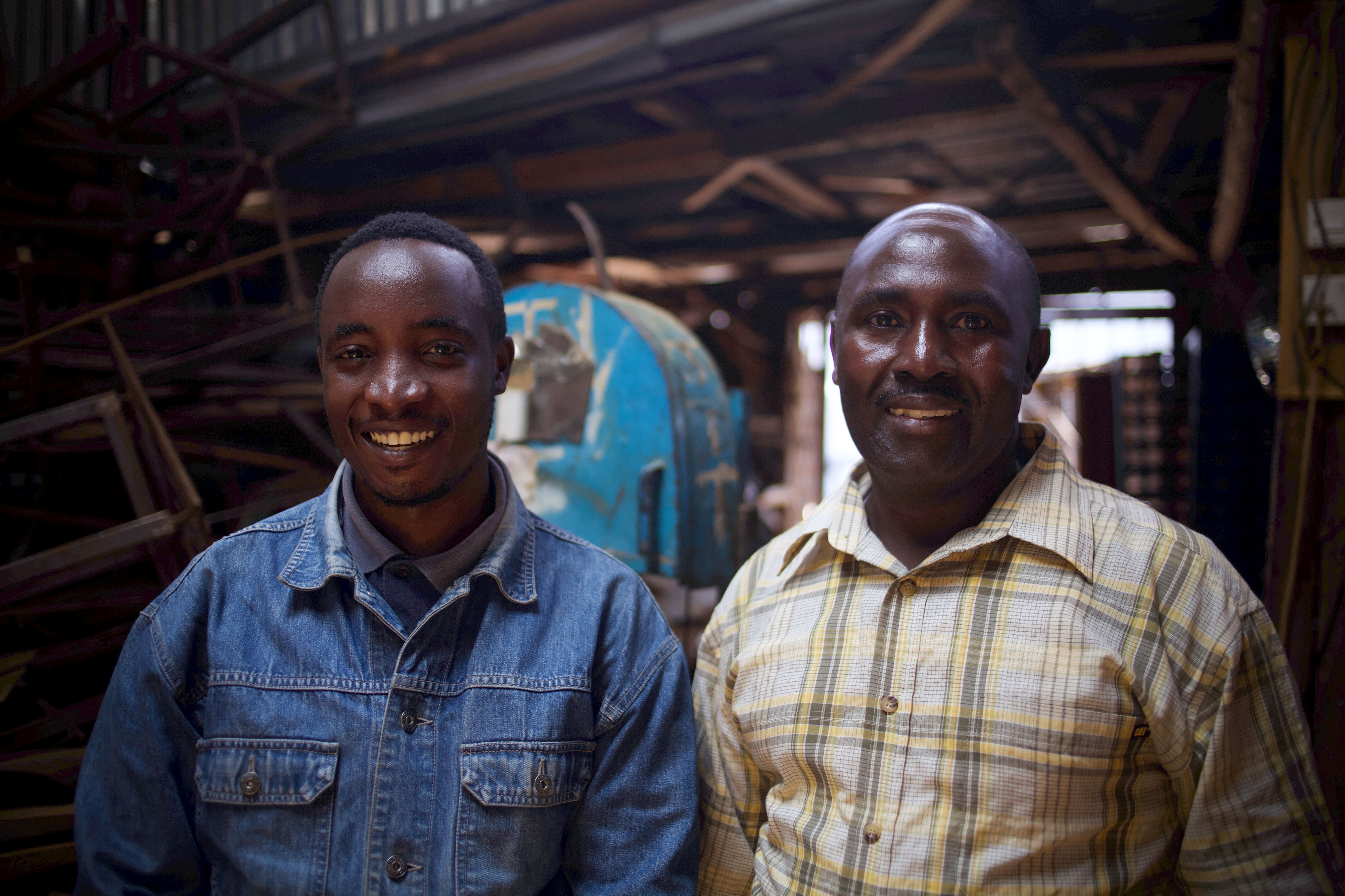 Two individuals stand next to each other and smile for the camera.