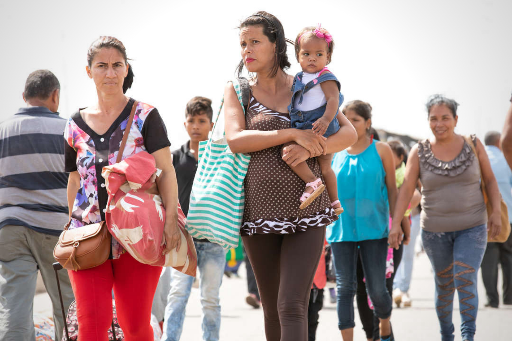 Families walking together at a border crossing.
