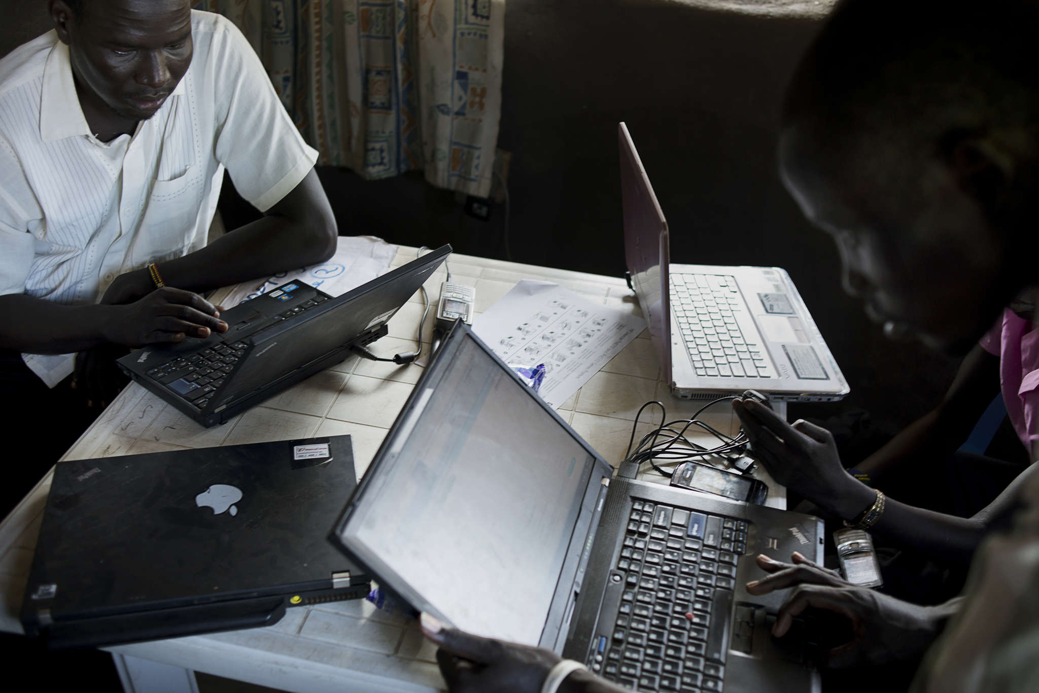 A group of people using laptop computers.