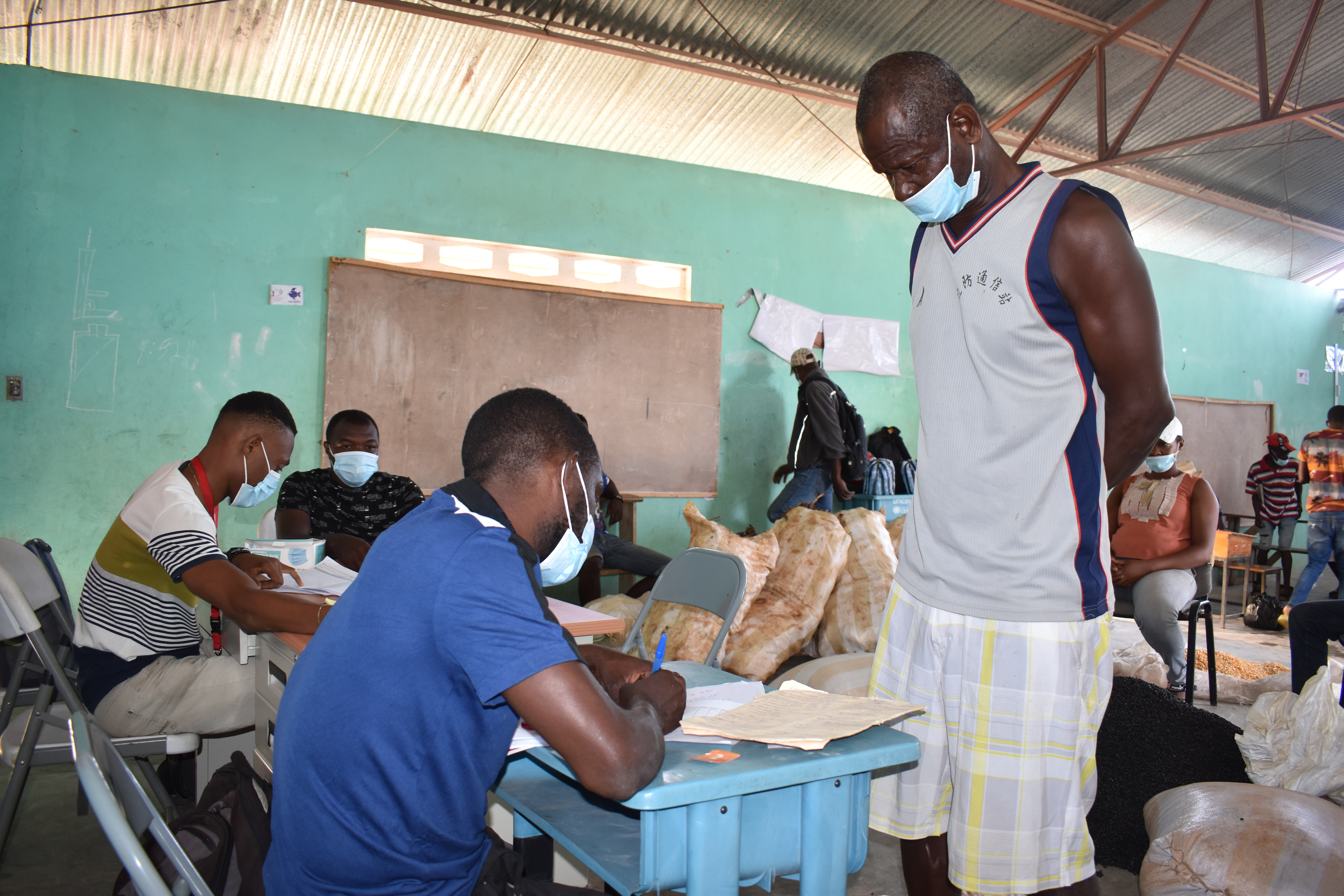 A farmer signing up to receive supplies as part of a long-term recovery program. 