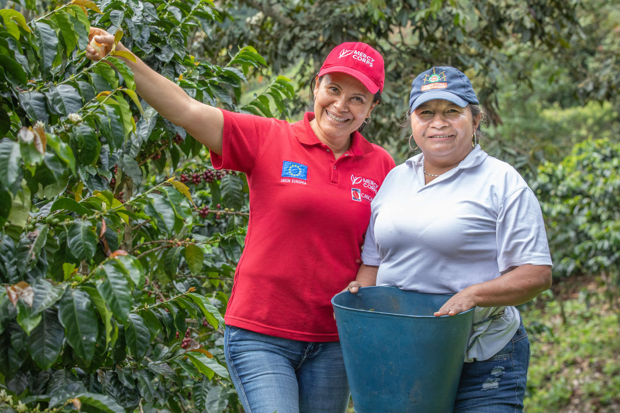 Two people standing together in an orchard.