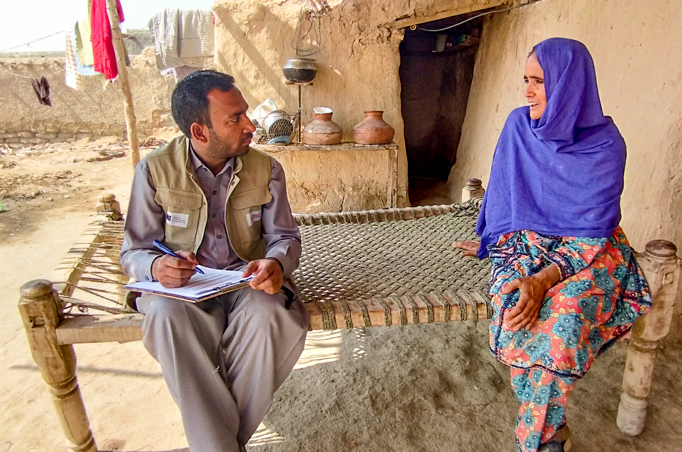 A mercy corps team member listening to someone speaking.