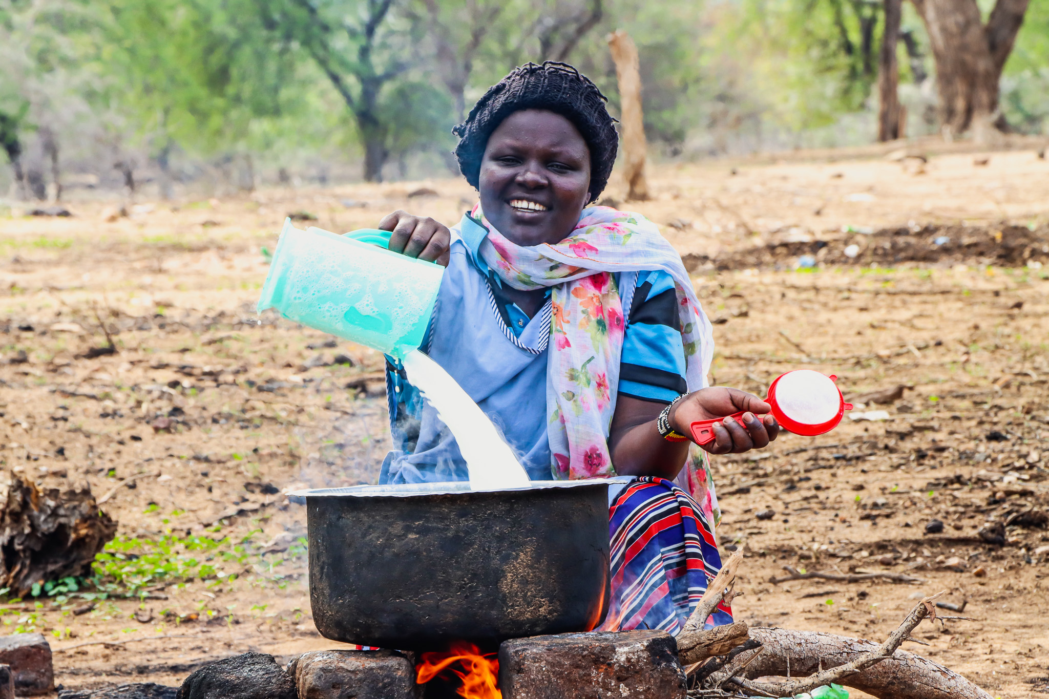 A person skimming milk.