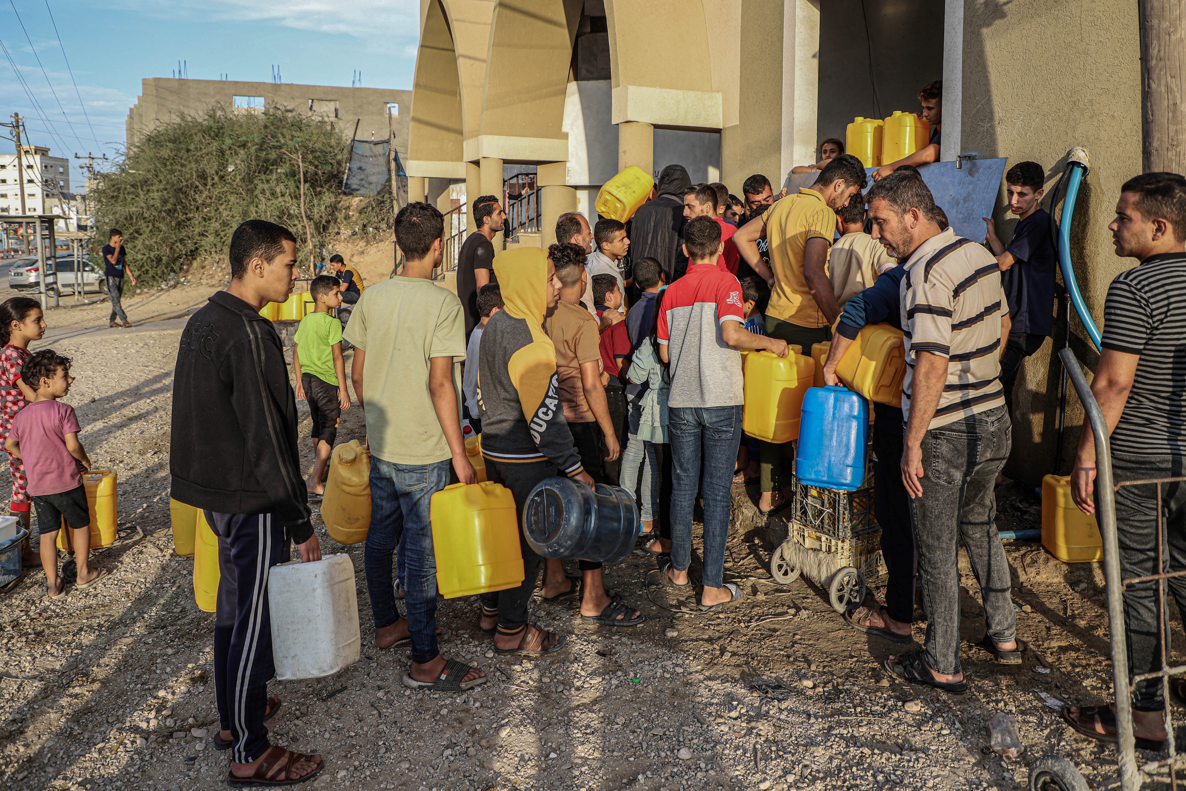 People queue to fetch water in the southern Gaza Strip city of Khan Younis, on Nov. 11, 2023. Photo by Rizek Abdeljawad/Xinhua via Getty Images