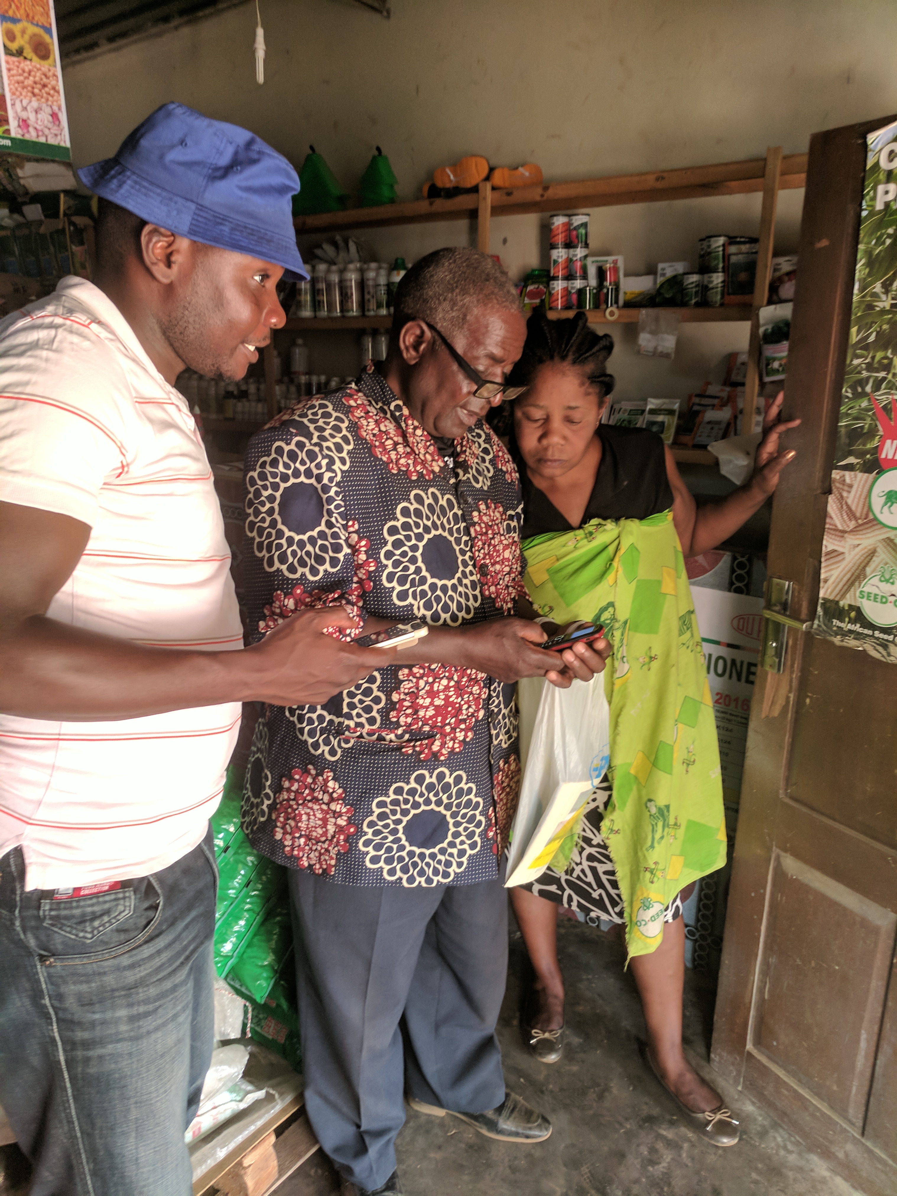 group of three people looking at a phone