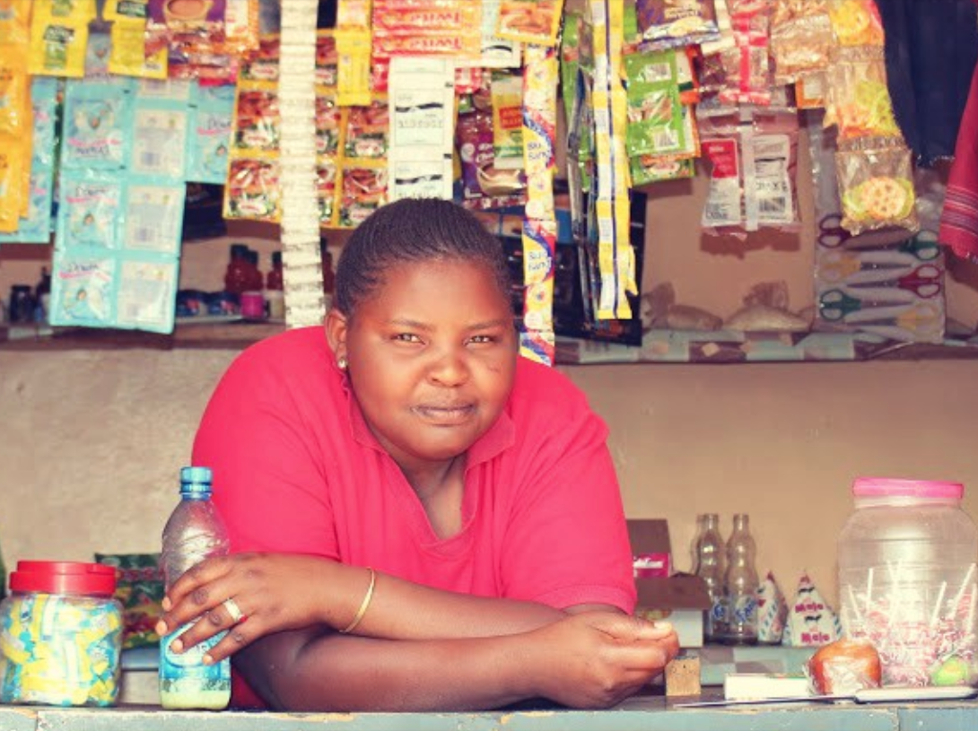 woman leaning on a counter looking at the camera