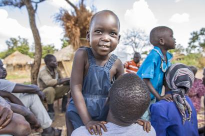 boy in Uganda in a circle of people