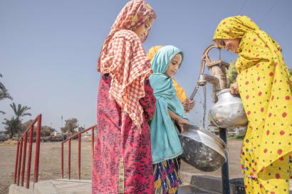 Pakistani women use use one of 70 water pumps that Mercy Corps rehabilitated after historic flooding.