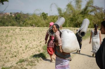 Women walking and carrying supplies