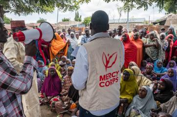 Mercy corps employee speaking to community.