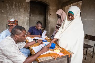 Young woman uses cash voucher.