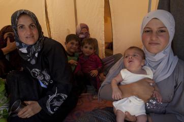 Refugee family in a tent.