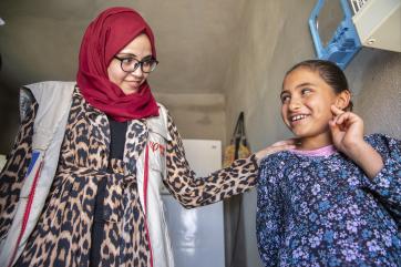 Woman and girl in jordan smiling at each other