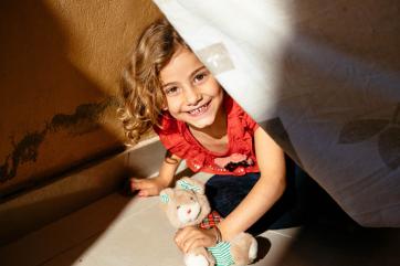 A young girl plays with a stuffed animal in lebanon