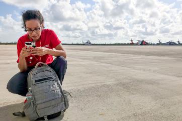 Mercy corps team member karla peña waits on the tarmac in nassau, bahamas