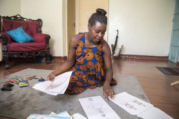 Young woman displaying her designs