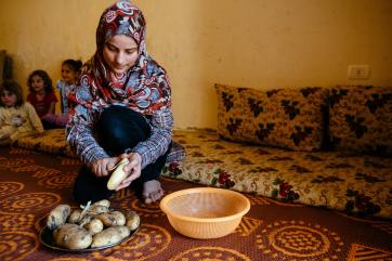 A girl prepares potatoes in lebanon
