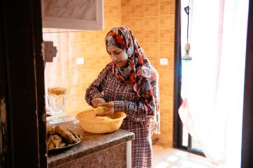 A girl prepares potatoes in lebanon