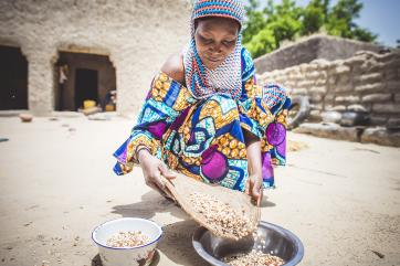 A woman prepares beans near her home in niger