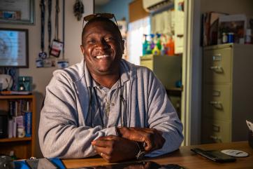 Bahamian man smiling in his office.