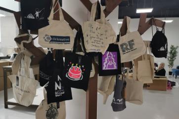 Hat rack used to display textile bags made by teenah, a jordanian small business.