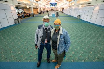 The owners of a small business pose for the camera in portland international airport where their shop is located.