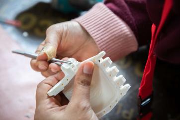 A person puts together a new prosthetic hand.