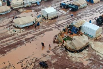 Tents align flooded pathways in al-rayyan camp after a large storm struck the area northwest of idlib.