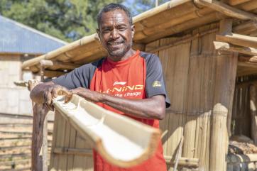 Timor leste man in garden building watering system.