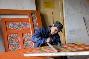 A worker making furniture.