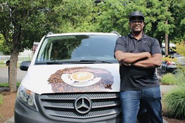 Eddy holford’s stands with his mobile café business vehicle.