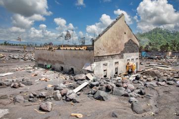 In curah koboan, java, lasiati tries to salvage anything she can find in her family’s home, which lies half-buried in ash near mt. semeru after its most recent eruption.