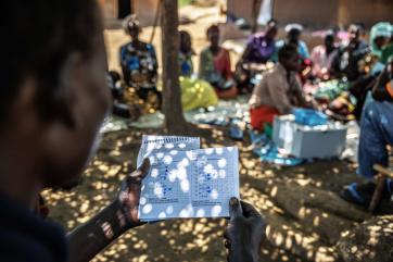 A group member looks through his savings records. 