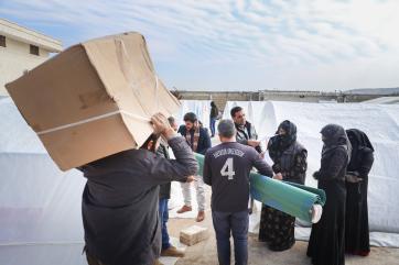 People carrying emergency kits.