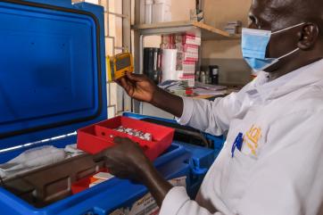 Nurse timothy munuve checks vaccines at mata in kenya.
