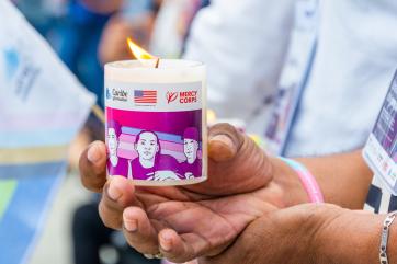A candle honoring lgbtq people killed in recent attacks.