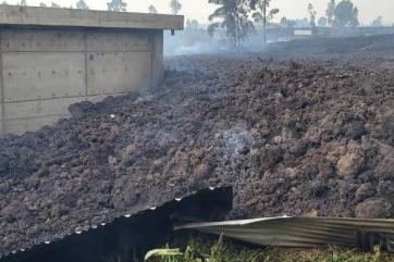 Steam rising out of lava that destroyed a part of the 1.3-million-gallon bushara reservoir.