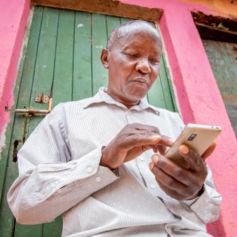 Kenyan man on his smartphone