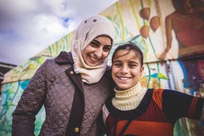 Woman and adolescent girl smiling at the camera in jordan