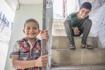 Two boys in a stairwell.