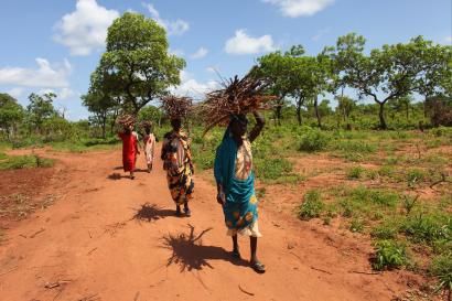 Woman in south sudan walking down dirt path