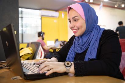 A person using a laptop computer.
